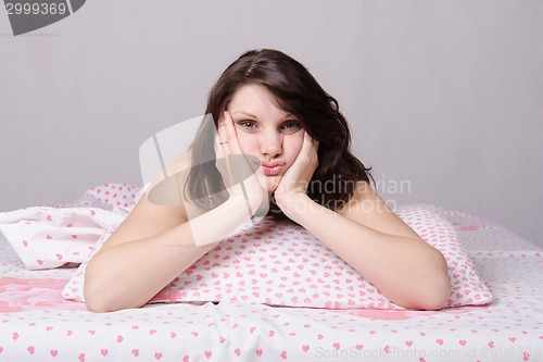 Image of The girl woke up in bed bored