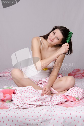 Image of Girl combing her tangled hair