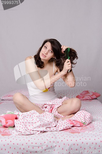 Image of Girl combing her hair tangled strongly