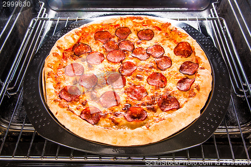 Image of Pepperoni pizza in the oven.