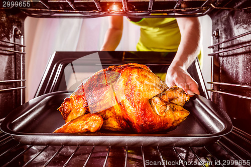 Image of Cooking chicken in the oven at home.