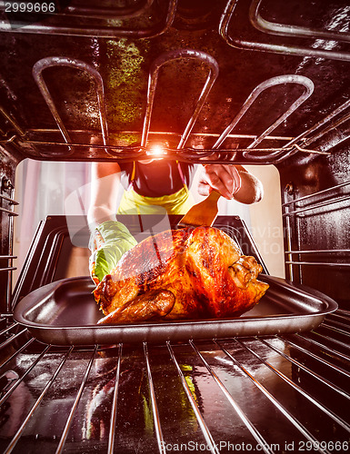 Image of Cooking chicken in the oven at home.