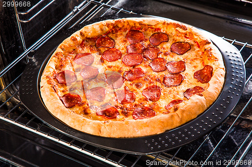 Image of Pepperoni pizza in the oven.