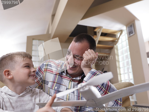 Image of father and son assembling airplane toy