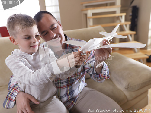 Image of father and son assembling airplane toy