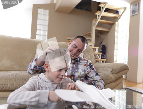 Image of father and son assembling airplane toy