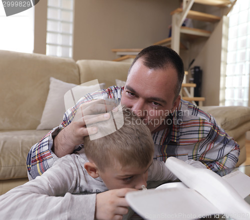 Image of father and son assembling airplane toy