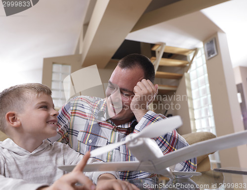 Image of father and son assembling airplane toy