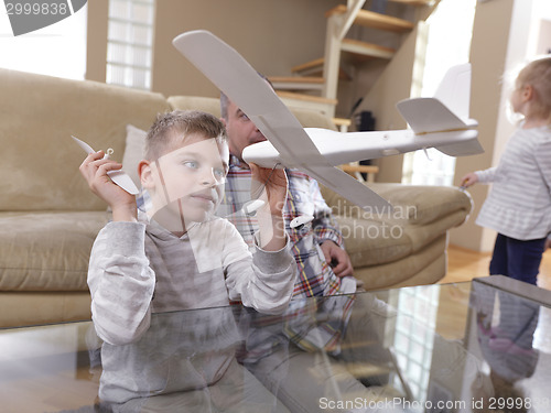 Image of father and son assembling airplane toy