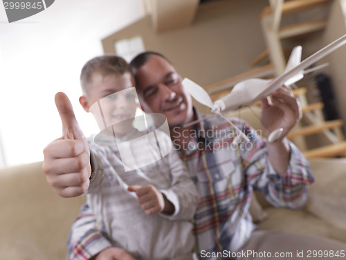 Image of father and son assembling airplane toy