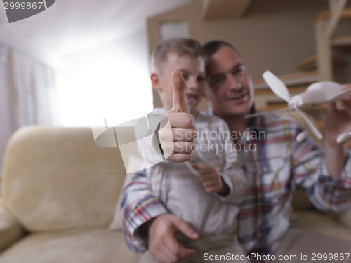 Image of father and son assembling airplane toy