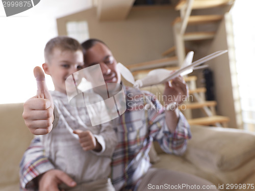 Image of father and son assembling airplane toy