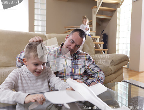 Image of father and son assembling airplane toy