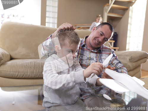 Image of father and son assembling airplane toy