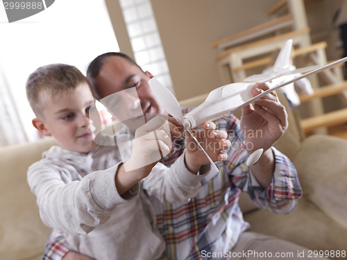 Image of father and son assembling airplane toy