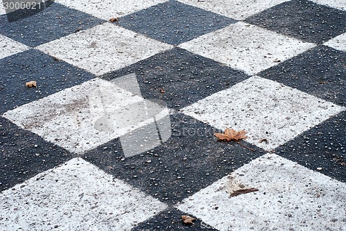 Image of chess board painted on the asphalt ground