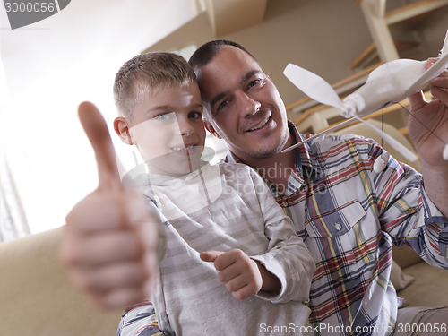 Image of father and son assembling airplane toy