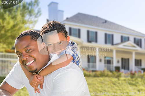 Image of African American Father and Mixed Race Son, House Behind