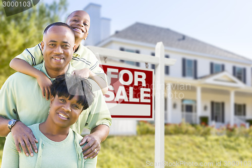 Image of African American Family In Front of Sale Sign and House