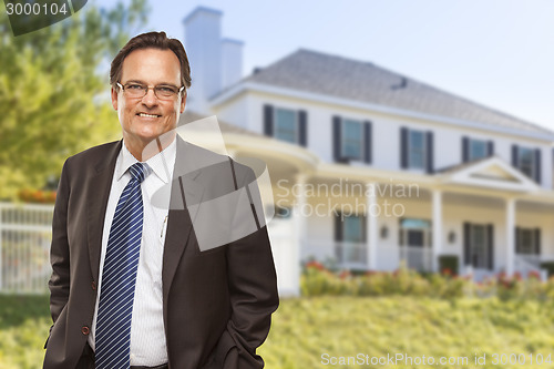 Image of Attractive Businessman In Front of Nice Residential Home