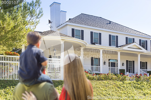 Image of Mixed Race Young Family Looking At Beautiful Home