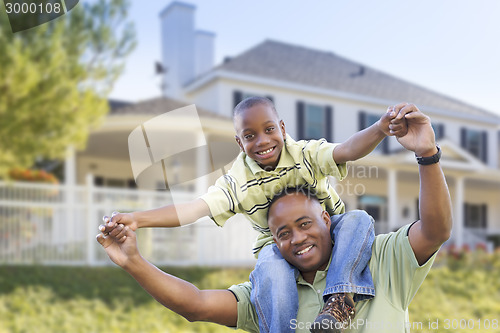 Image of Playful African American Father and Son In Front of Home