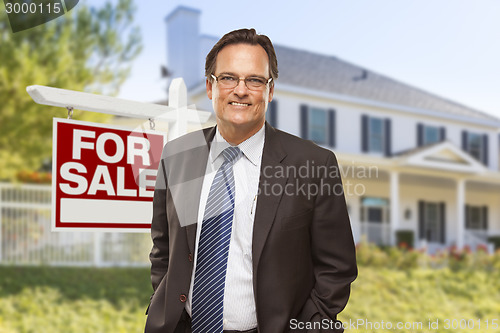 Image of Real Estate Agent in Front of For Sale Sign, House