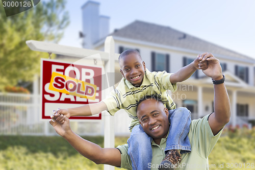 Image of African American Father and Son, Sold Sign and Home