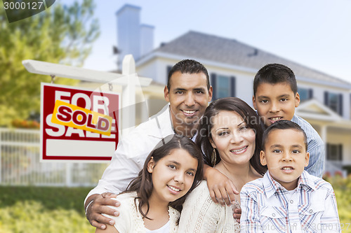 Image of Hispanic Family in Front of Sold Real Estate Sign, House