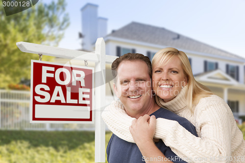 Image of Couple in Front of New House and Real Estate Sign