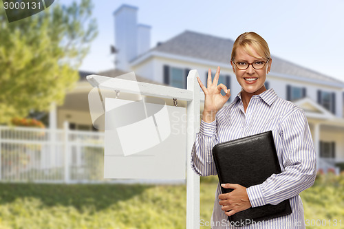 Image of Real Estate Agent in Front of Blank Sign and House