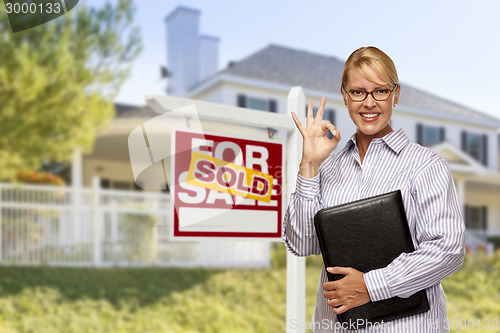 Image of Real Estate Agent in Front of Sold Sign and House