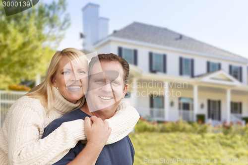 Image of Happy Couple Hugging in Front of House