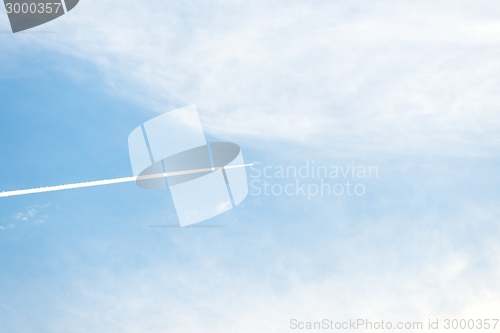 Image of Airplane moving across blue sky