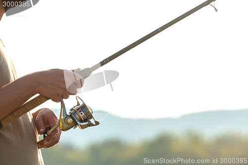 Image of Modern clean fishing rod in hands