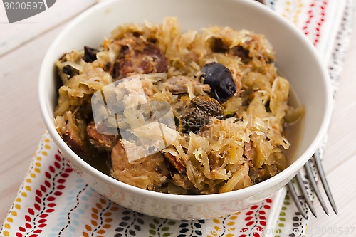 Image of traditional polish sauerkraut (bigos) with mushrooms and plums