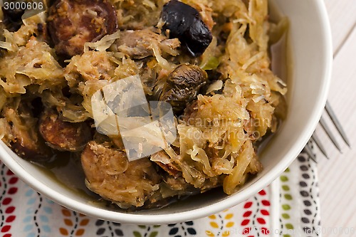 Image of traditional polish sauerkraut (bigos) with mushrooms and plums