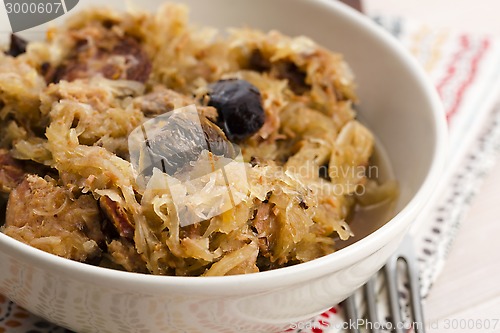 Image of traditional polish sauerkraut (bigos) with mushrooms and plums