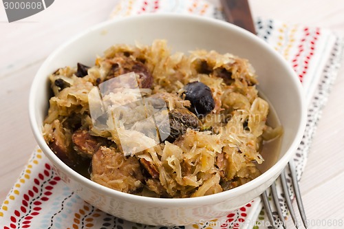 Image of traditional polish sauerkraut (bigos) with mushrooms and plums