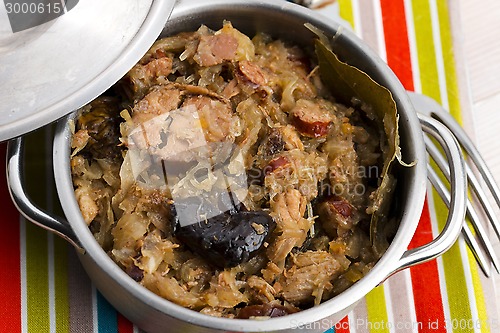 Image of traditional polish sauerkraut (bigos) with mushrooms and plums