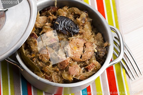 Image of traditional polish sauerkraut (bigos) with mushrooms and plums