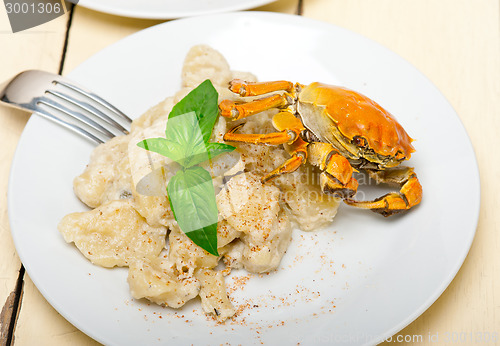 Image of Italian gnocchi with seafood sauce with crab and basil