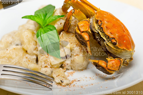 Image of Italian gnocchi with seafood sauce with crab and basil