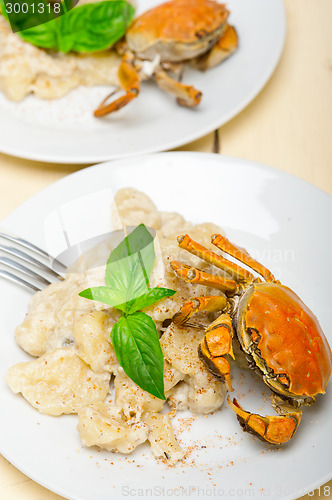 Image of Italian gnocchi with seafood sauce with crab and basil