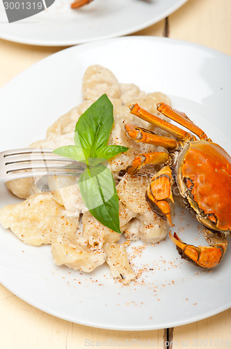 Image of Italian gnocchi with seafood sauce with crab and basil