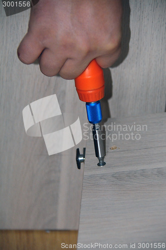 Image of Closeup of a hand with a screwdriver