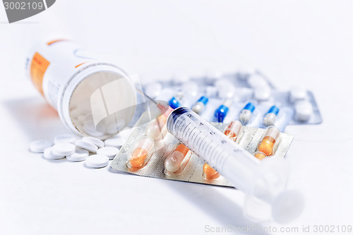 Image of Syringe with glass vials and medications pills 