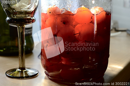 Image of glass jar with canned apples sunlit