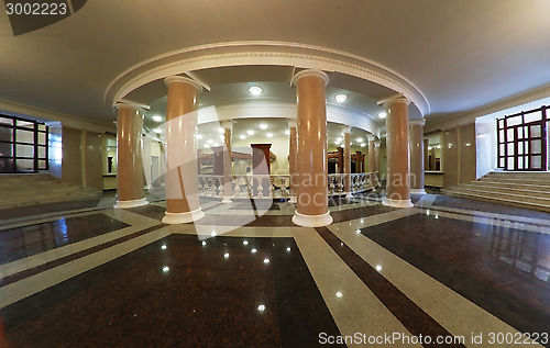 Image of theater foyer with columns and marble floors