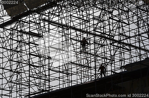 Image of workers assemble metal construction